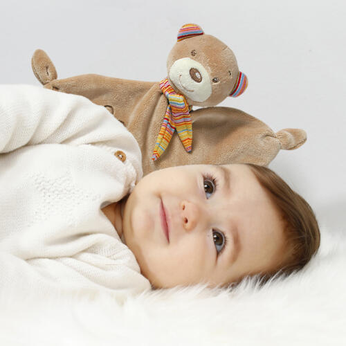 Ein Baby kuschelt mit dem Fehn Teddy Schnuffeltuch.