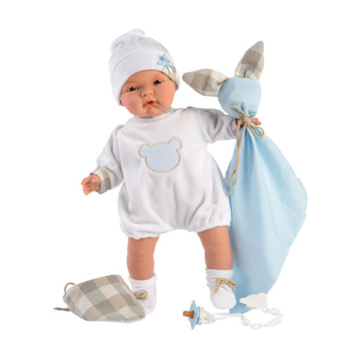 Die Babypuppe Joel hat ihre Kuscheldecke, ein Lätzchen und den Schnuller immer in ihrer Nähe.