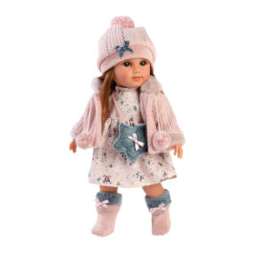 Die Puppe Nicole trägt ein hübsches, rosafarbenes Puppenoutfit mit einer niedlichen Umhängetasche.