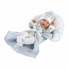 Die Babypuppe Bimbo mit ihrer Kuscheldecke. Das Gesicht ist mit einem frohen Babylachen gestaltet, das sofort die Herzen der Puppenmamas erschließt.