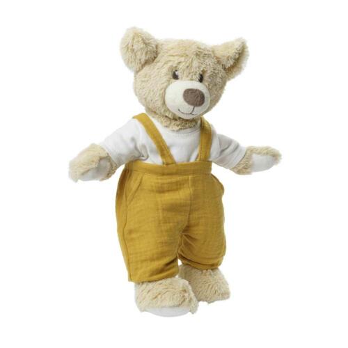 Ein Teddy trägt das niedliche Puppenoutfit in gelb und weiß.